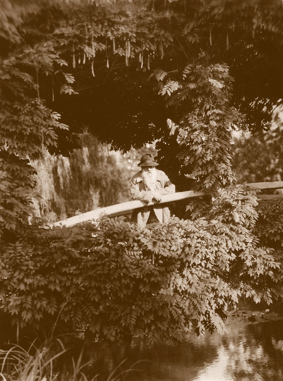 كلود مونيه على الجسر الياباني في حديقته في جيفرني ، حوالي 1920 بواسطة مصور فرنسي