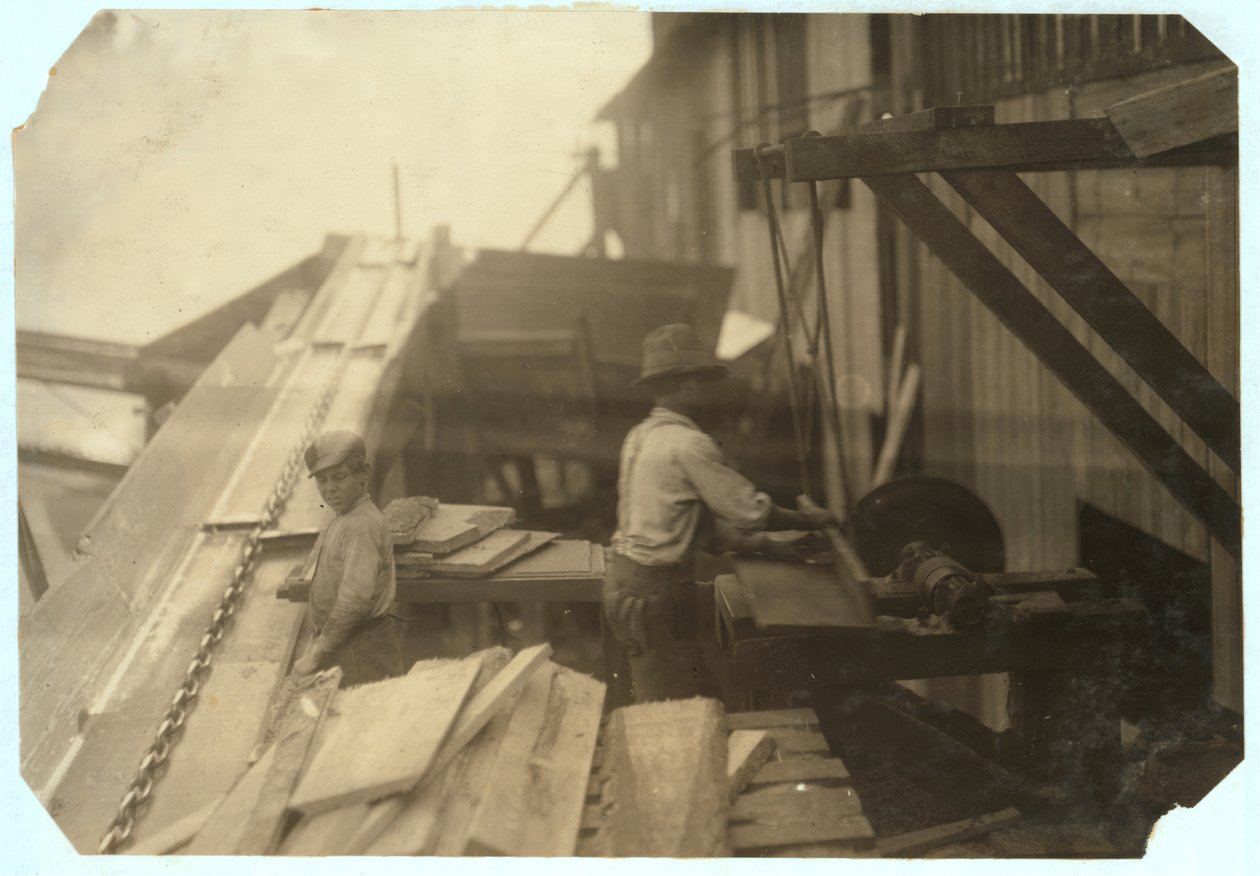 يأخذ تشارلي ماكبرايد البالغ من العمر 12 عامًا الخشب من شلال لمدة 10 ساعات في شركة Miller und Vidor Lumber Company ، بومونت ، تكساس ، حيث يكسب 50 سنتًا بينما يراه الصبي الآخر على منشار دائري غير محمي ، 191 بواسطة لويس ويكس هاين
