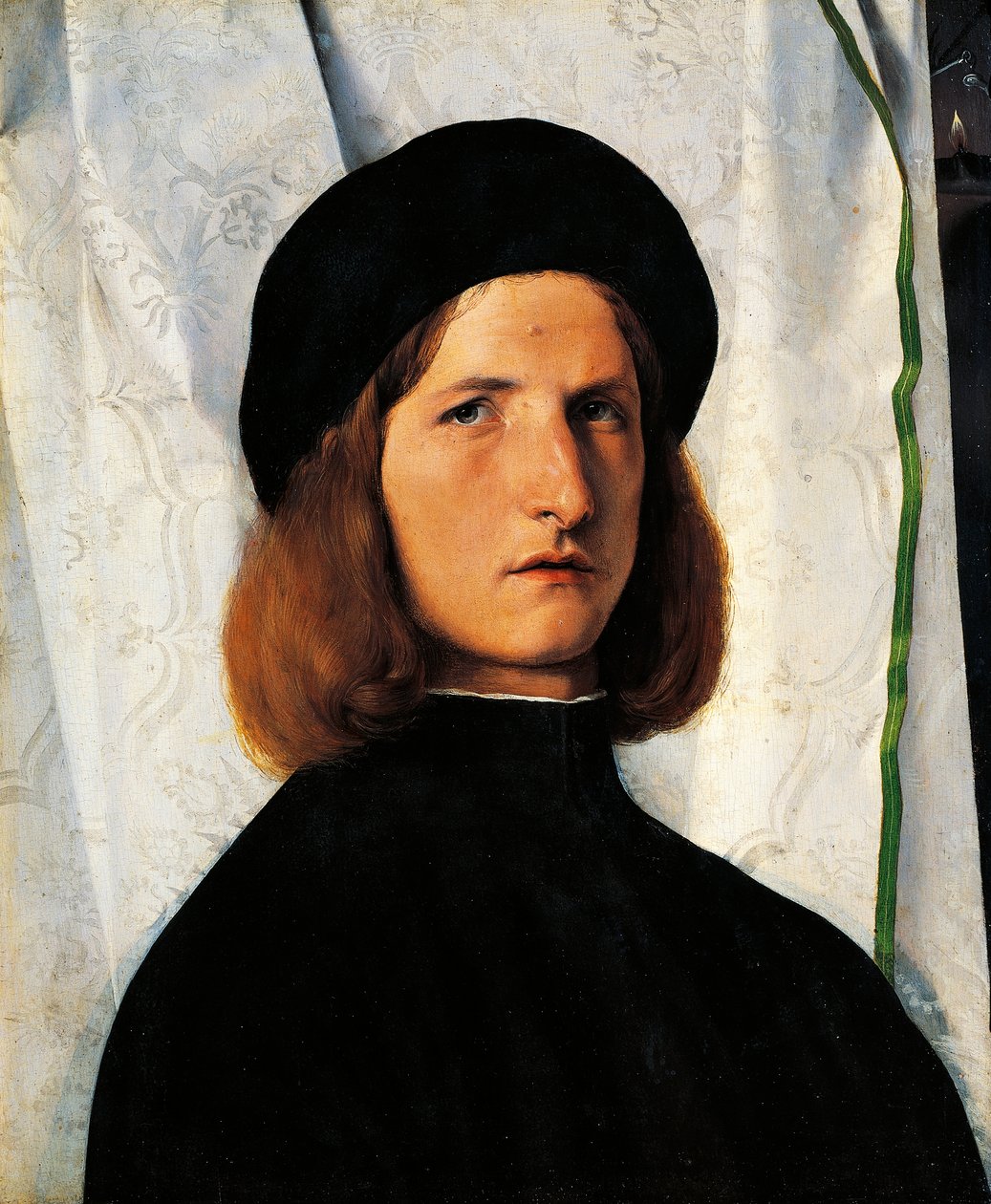Portrait of young man with lamp بواسطة لورينزو لوتو