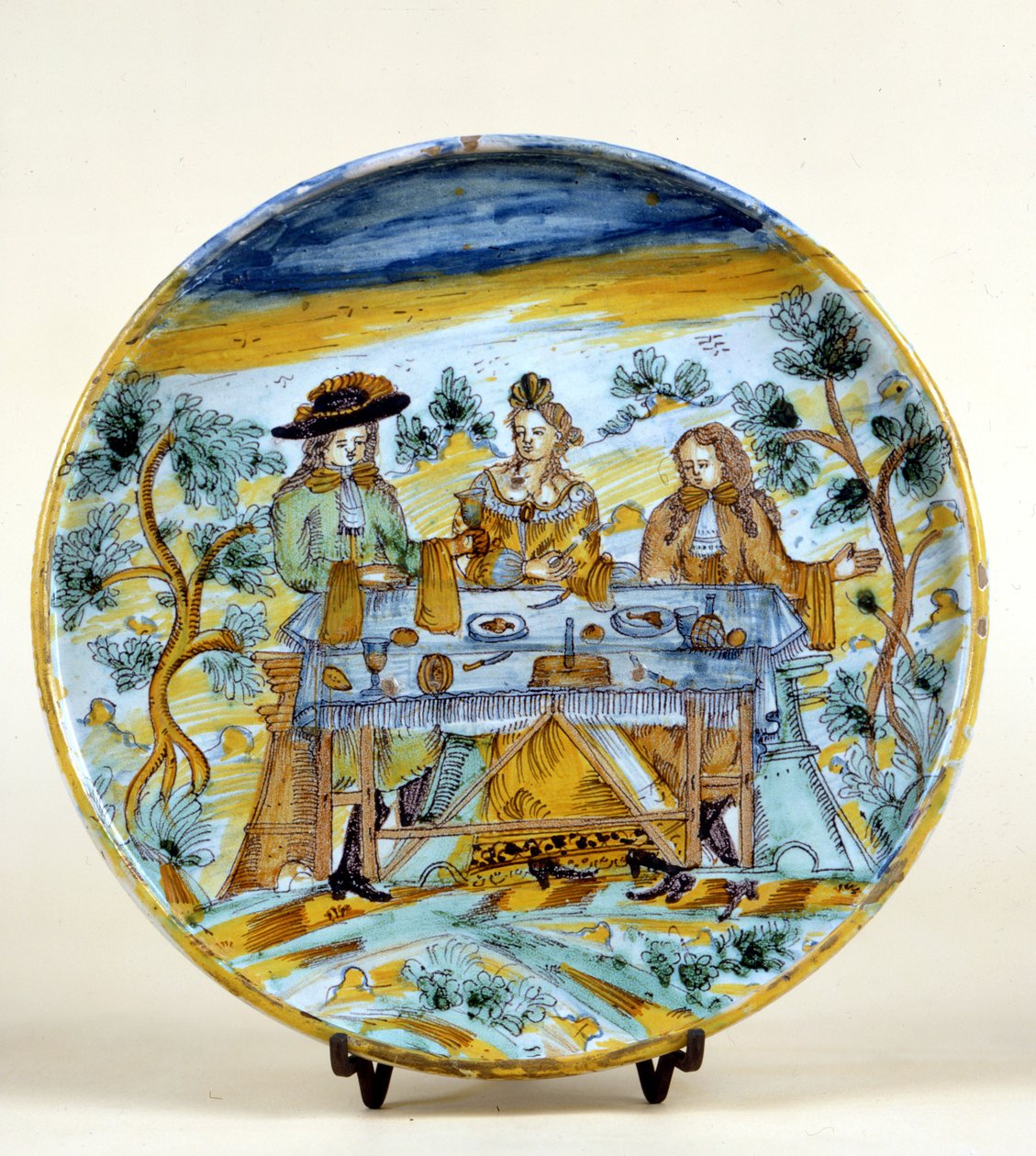 تمثيل مأدبة في الهواء الطلق على طبق خزفي من Talavera de la reina (إسبانيا). أوائل القرن السادس عشر. ميلانو ، متحف ديل كاستيلو. بواسطة المدرسة الاسبانية