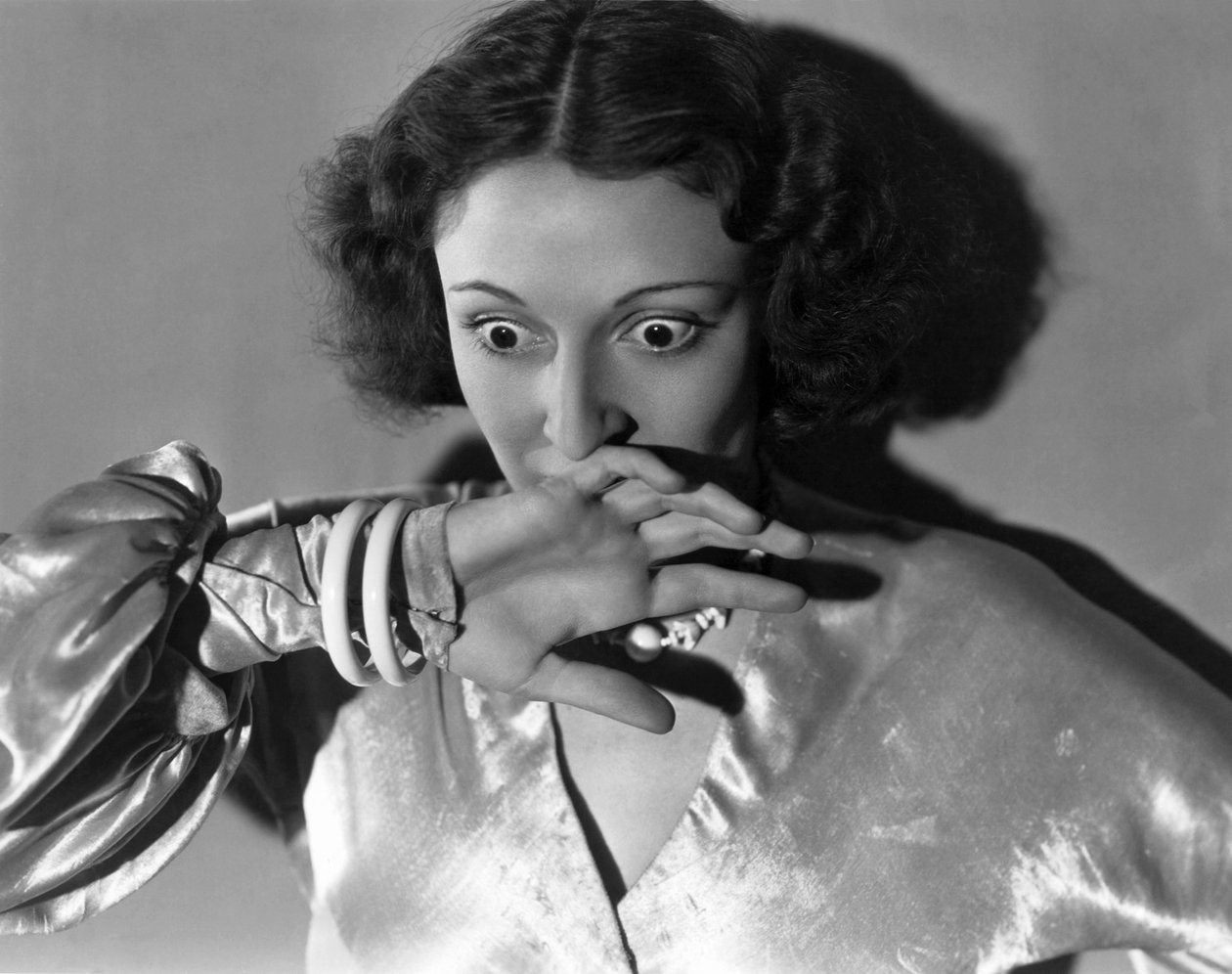 هوليوود ، كاليفورنيا: حوالي عام 1932 لقطة مقرّبة لامرأة شابة تغطي فمها في خوف. (ب / ث الصورة) بواسطة غير معروف
