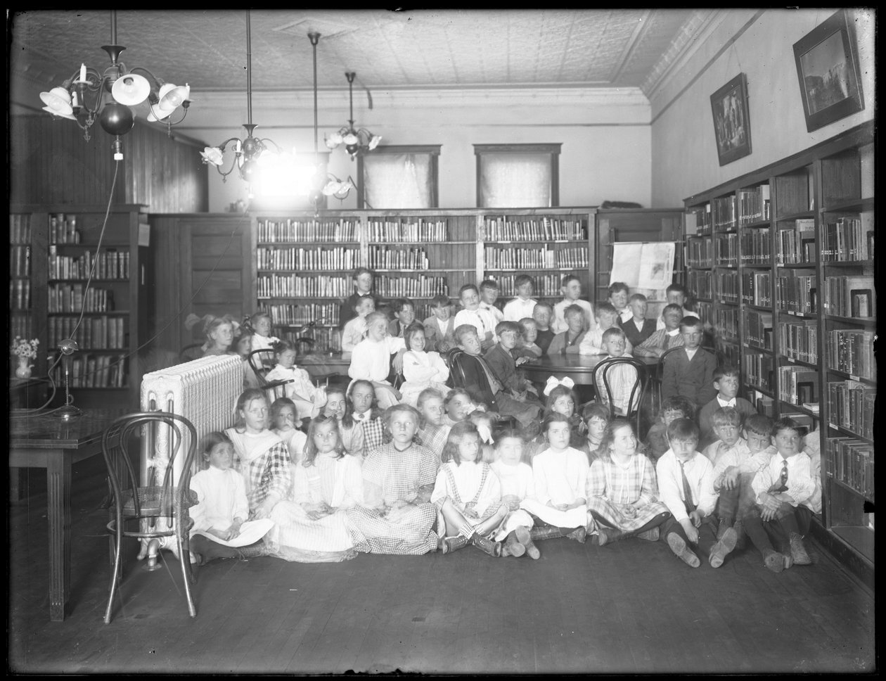 صورة جماعية للأطفال في غرفة القراءة لفرع مجهول من مكتبة Queens Borough العامة ، ج .1910 بواسطة وليام ديفيس هاسلر