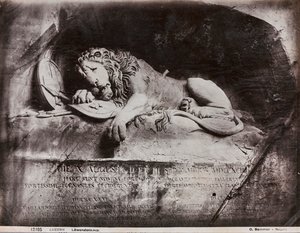 The sculptured monument of a lion by Lukas Ahorn in a rock face in a small park of Lucerna