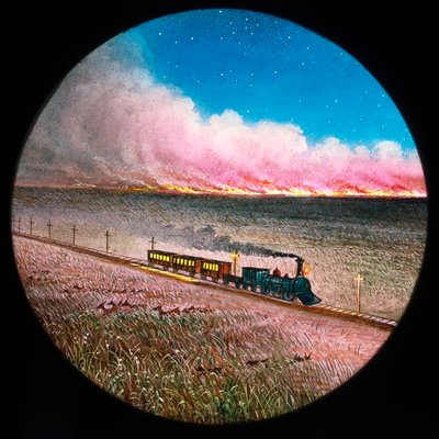 Prairie on fire with train, hand-coloured magic lantern slide بواسطة غير معروف غير معروف