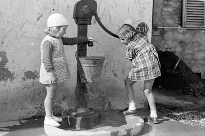 فتيات صغيرات يملأن دلوًا من الماء، 9 مايو 1939 (صورة بالأبيض والأسود) بواسطة فينتشنزو بالوتشي